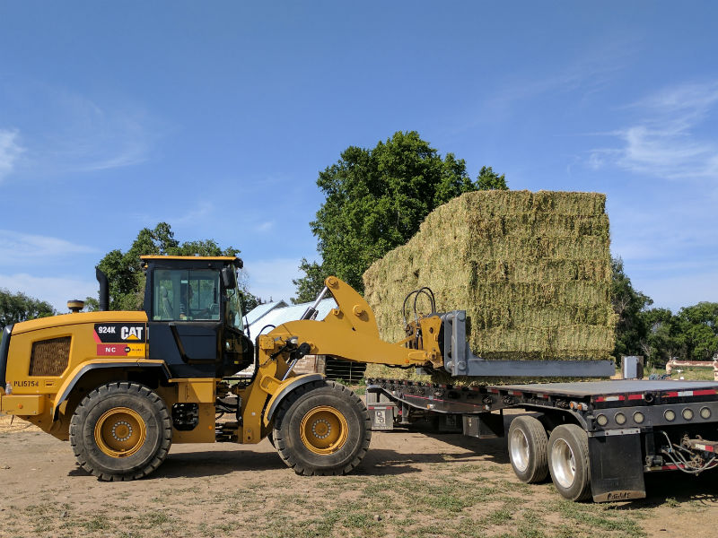 Clerf Standard Hay Clamp on CAT Wheel Loader loading Hay Truck